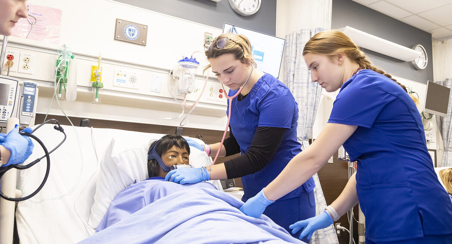Nursing students working on a patient