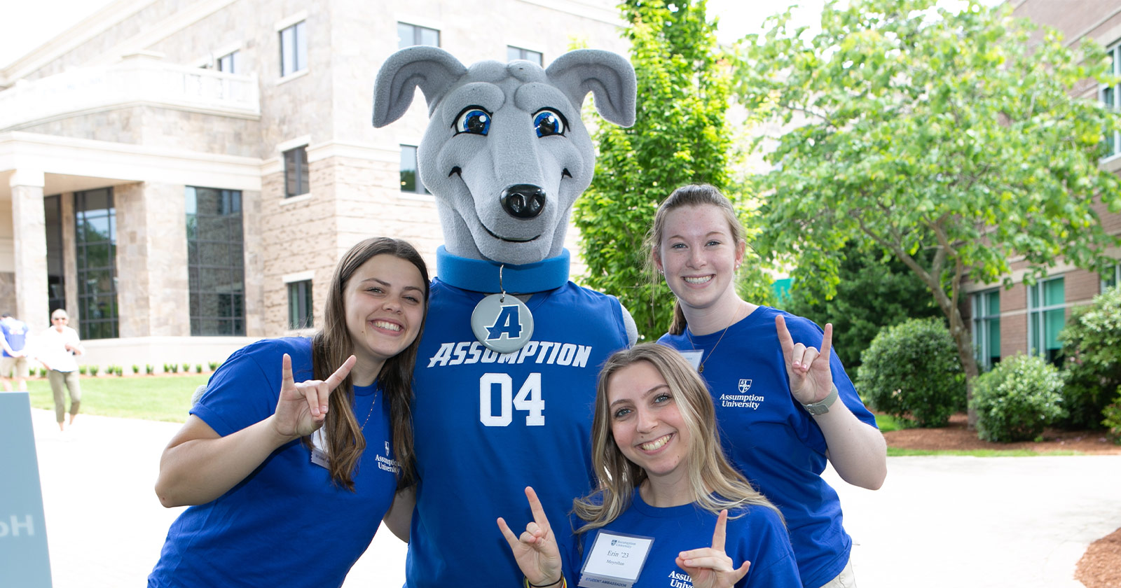 Assumption University mascot Pierre poses with students.