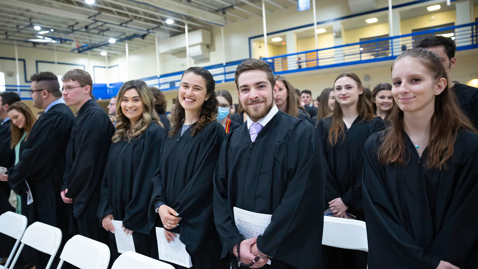 Assumption students wearing their commencement gowns at a baccalaureate Mass