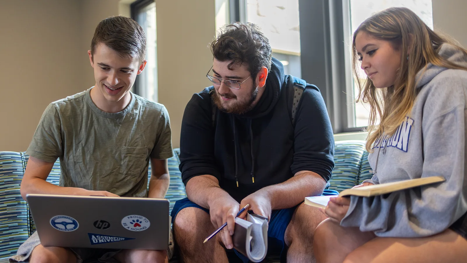 Assumption students looking at a computer screen